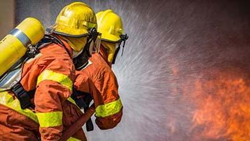 Firefighters spraying water on a blaze.